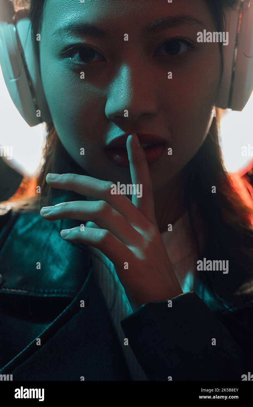 neon light face cyber music girl headphones hush Stock Photo