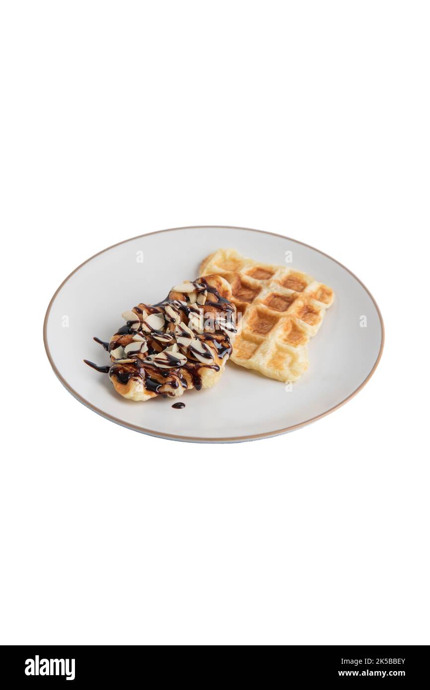 Croffles with almonds chocolate sauce topping and caramel on plate on white background isolated clipping path Stock Photo