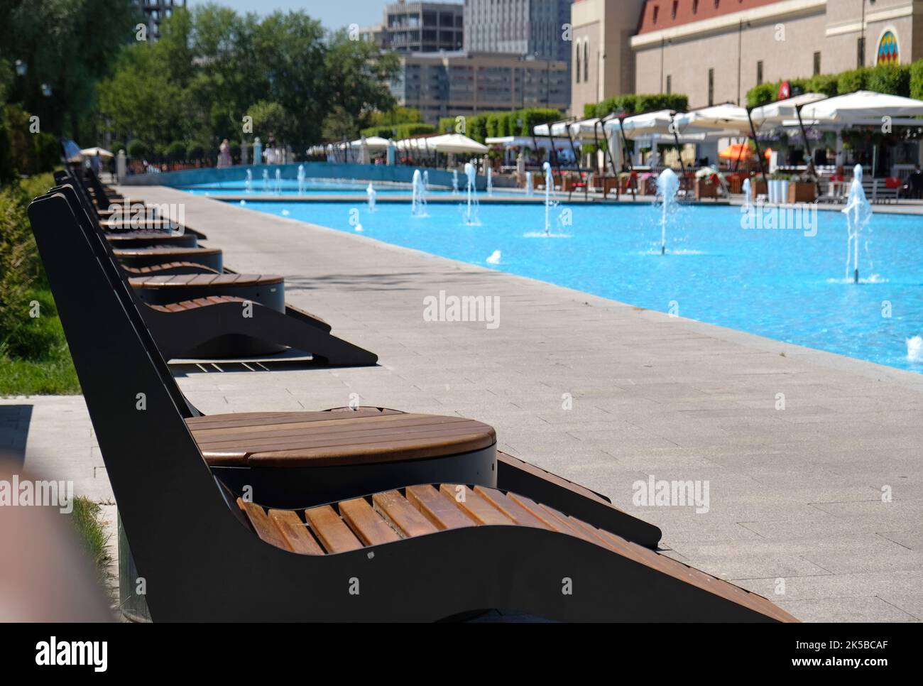 A recreation and relaxation area by the pool in a hotel or a fountain ...