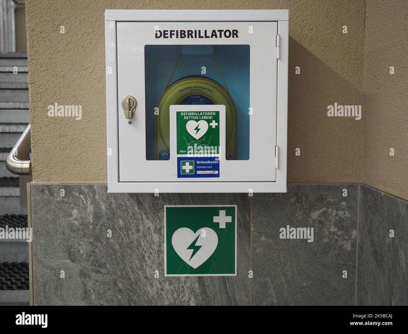 The defibrillator box hanging on the wall in the public building Stock
