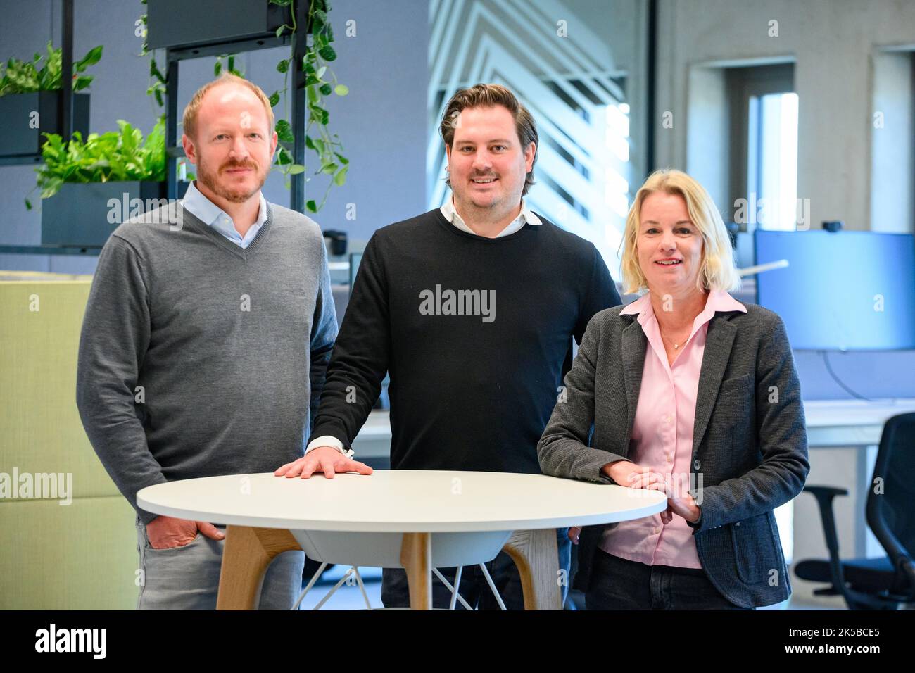 Hamburg, Germany. 07th Oct, 2022. Dr. Enno Wolf (l-r), Chief Operating Officer at Lichtblick, Constantin Eis, Chief Executive Officer at Lichtblick, and Tanja Schumann, Chief Financial Officer at Lichtblick, in the new offices. Energy supplier Lichtblick unveils its new headquarters in the Connexion office building in the Münzviertel district, which will be officially inaugurated on October 10. Credit: Jonas Walzberg/dpa/Alamy Live News Stock Photo