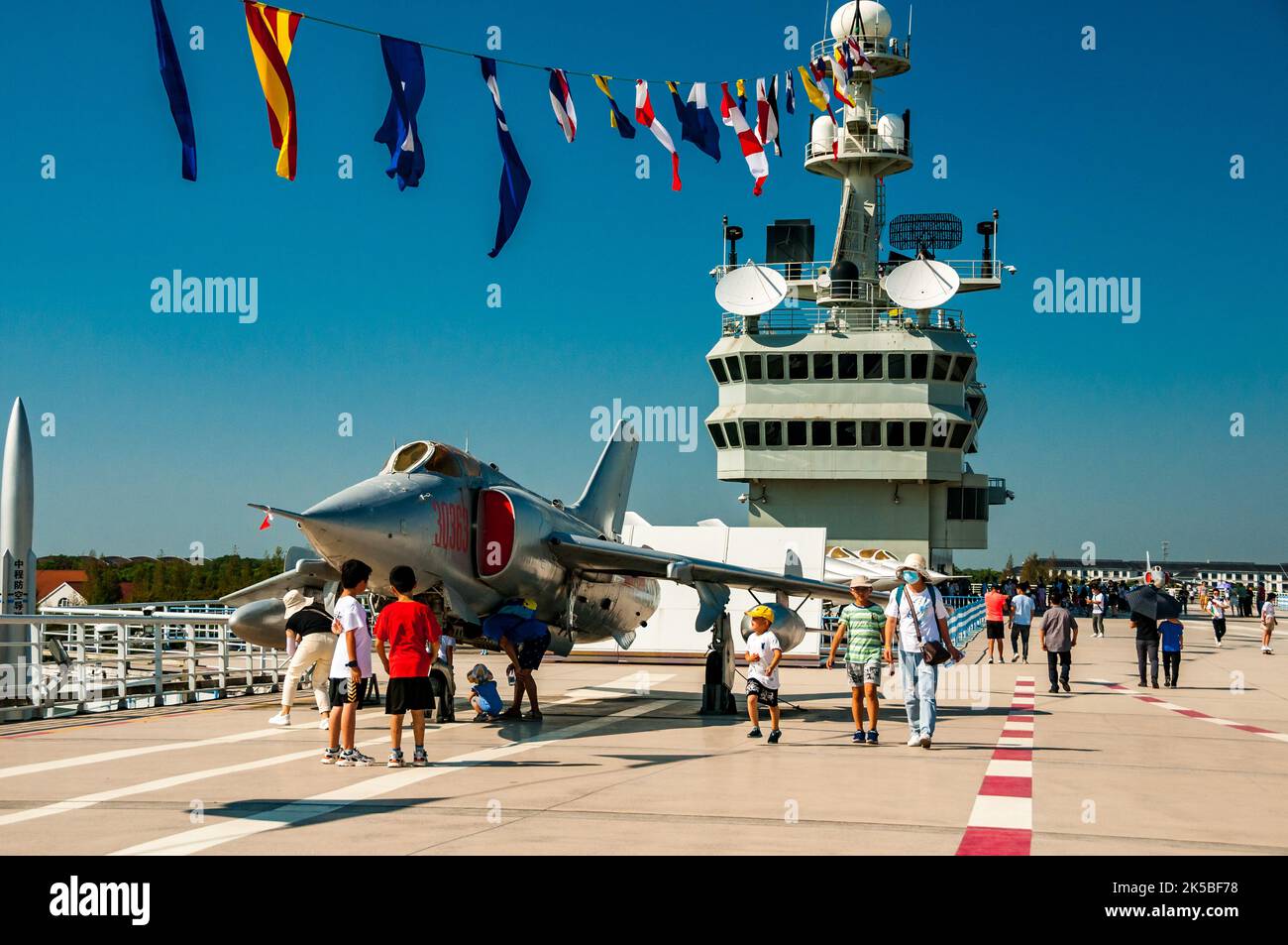 A Nanchang Q-5 ground attack aircraft, a Chinese development of the MiG-19, seen on the flight deck of a fake, concrete, aircraft carrier at Oriental Stock Photo