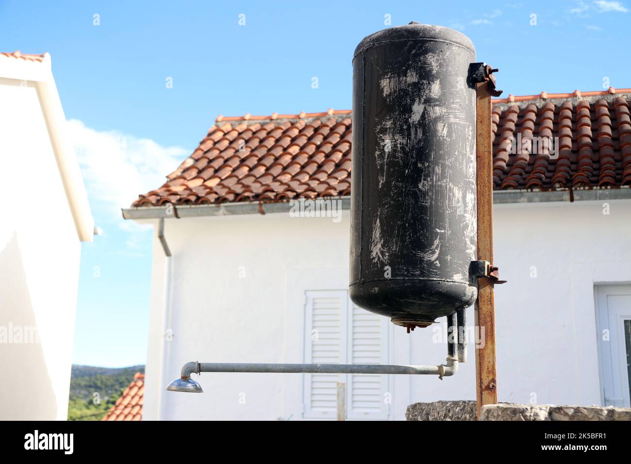 an outdoor shower with water that is heated from a solar water heater