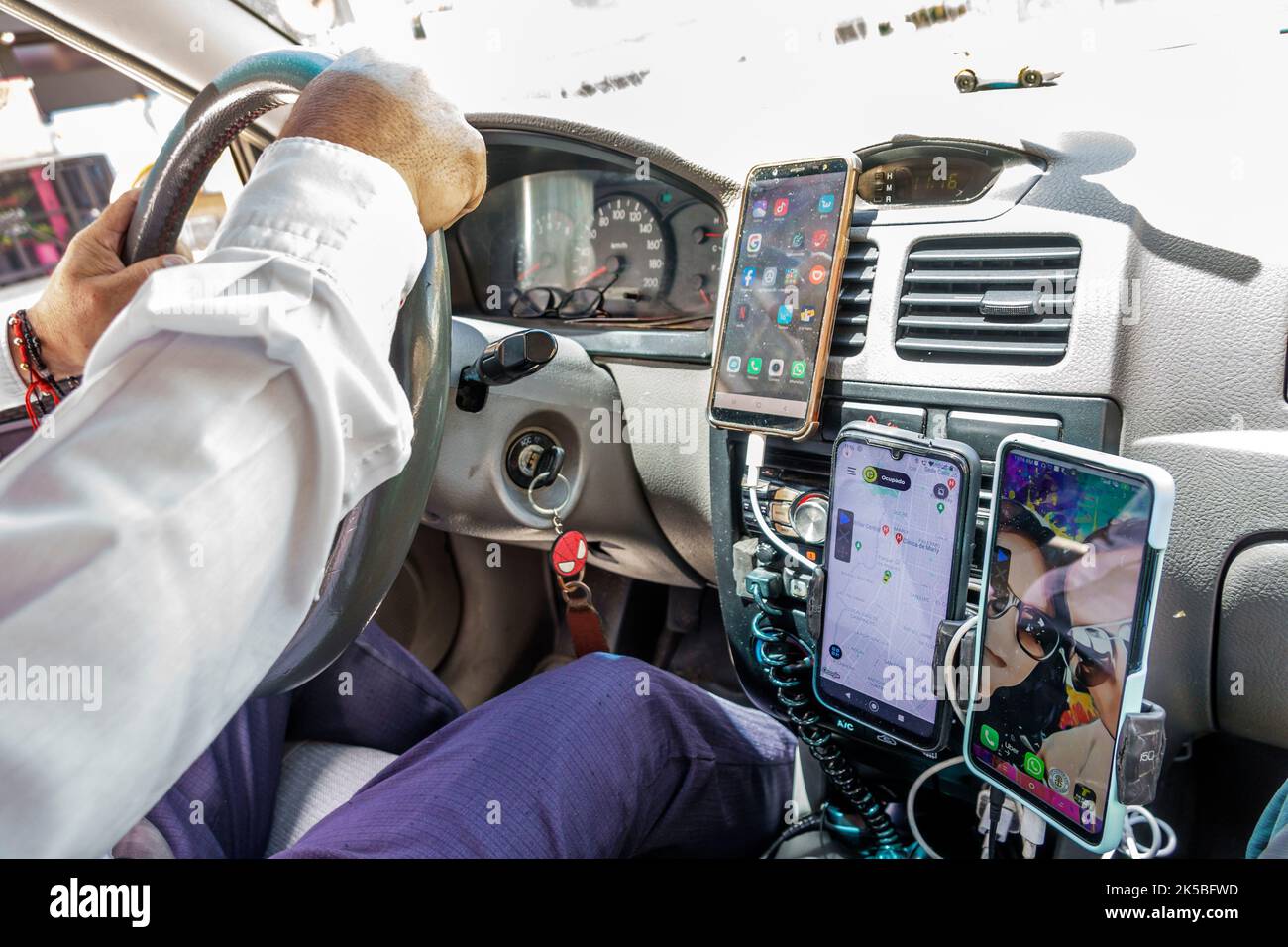 Bogota Colombia,Avenida Carrera 7 taxi driver driving,man men male,interior inside vehicle car dashboard smartphone GPS phone cradle,Colombian Colombi Stock Photo