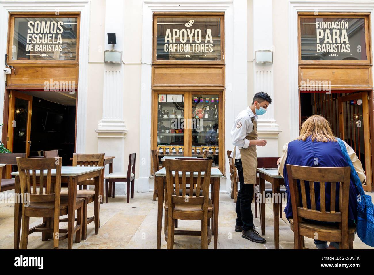 Bogota Colombia,Veracruz Calle 16 Arte y Pasion coffeehouse Escuela de Baristas interior inside,server waiter barista taking order,restaurant restaura Stock Photo