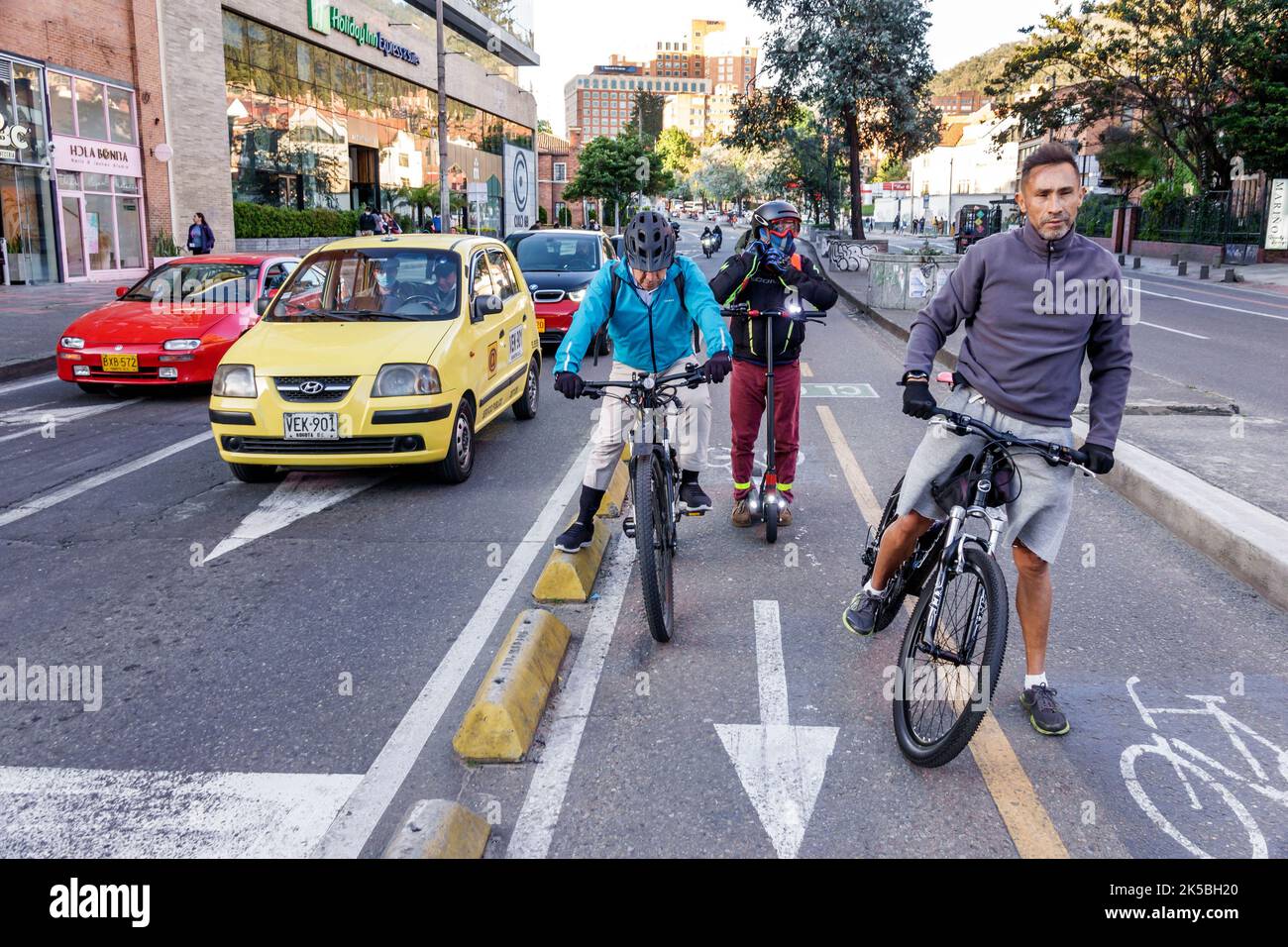 Bogota Colombia,Chapinero Norte Avenida Carrera 7,traffic protected segregated bicycle lane cycling man men male,resident residents commuter commuters Stock Photo