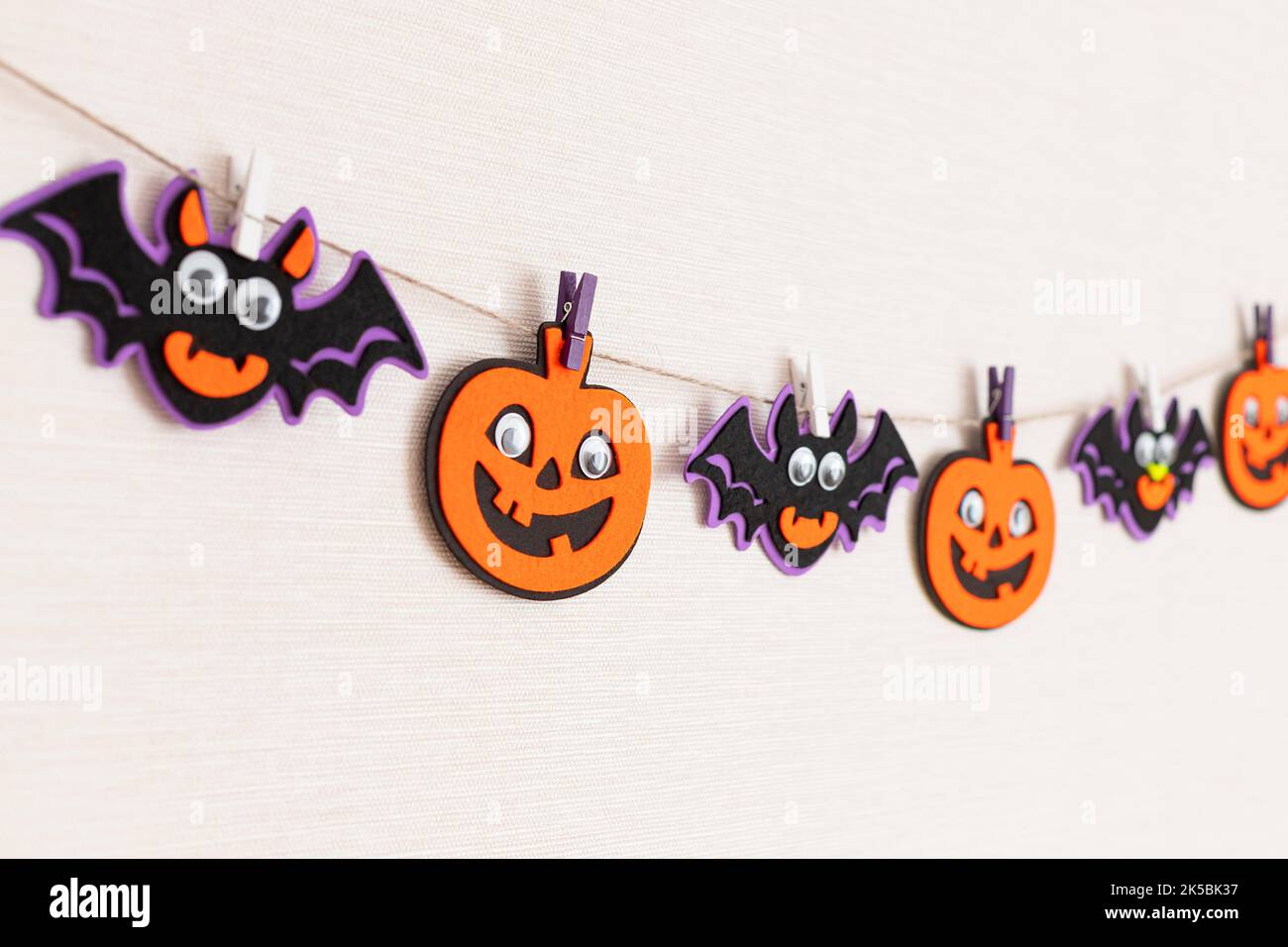 festive garland or banner with pumpkins and bats over white background Stock Photo