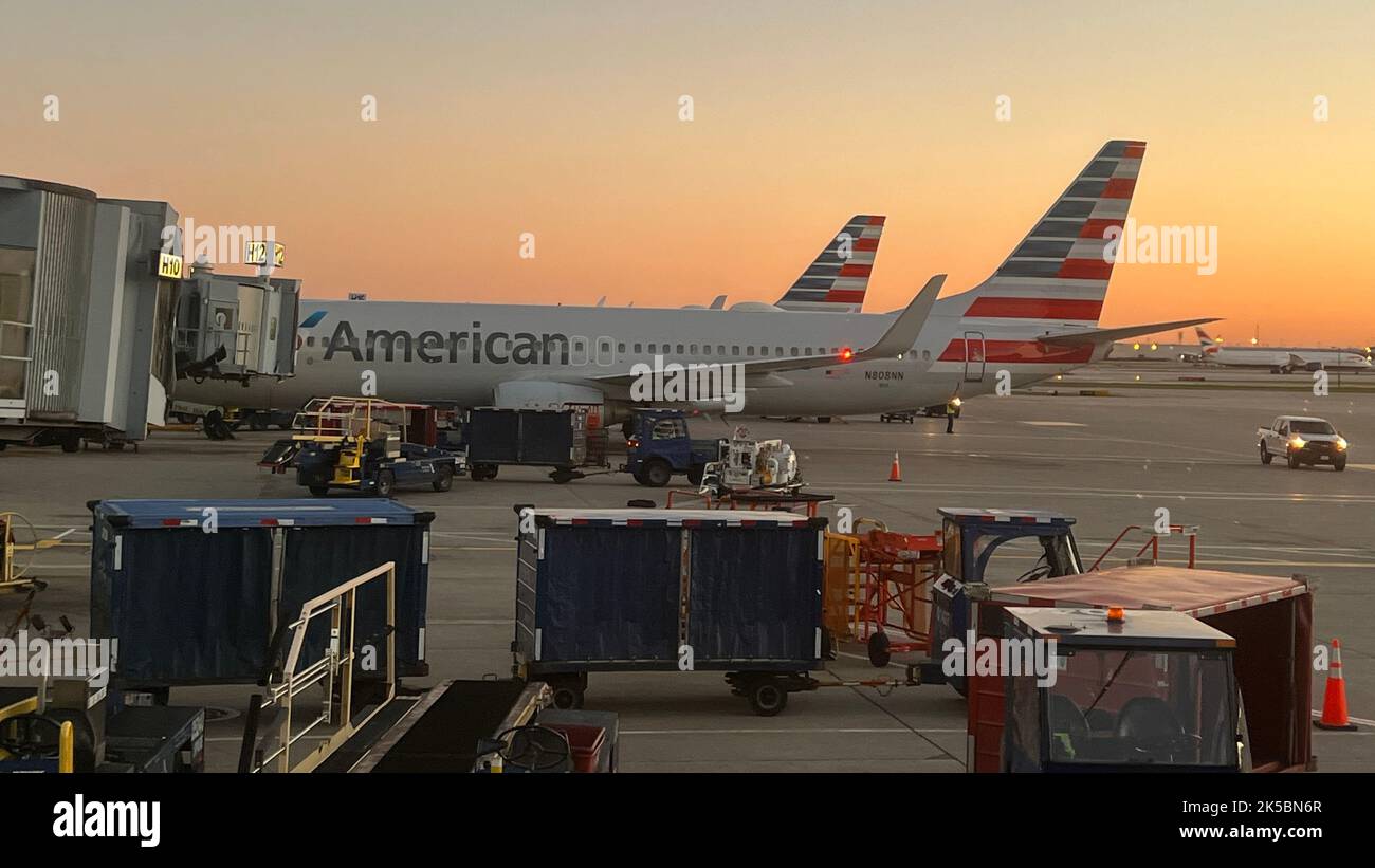 American Airlines planes parked at the gate at Chicago O'Hare International Airport at sunset. Stock Photo