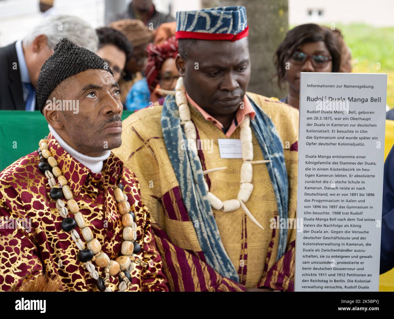 Ulm, Germany. 07th Oct, 2022. King Jean-Yves Eboumbou Douala Bell (l) from Cameroon stands next to a stele with Guy Klouemo, representative of the King of Bangoua. By naming the square near the new justice building, the city of Ulm commemorates Rudolf Duala Manga Bell, who went to school in Ulm for a few years at the end of the 19th century before returning to his homeland and - as king of his people - being executed by the German colonial administration in 1914 after a mock trial. Credit: Stefan Puchner/dpa/Alamy Live News Stock Photo
