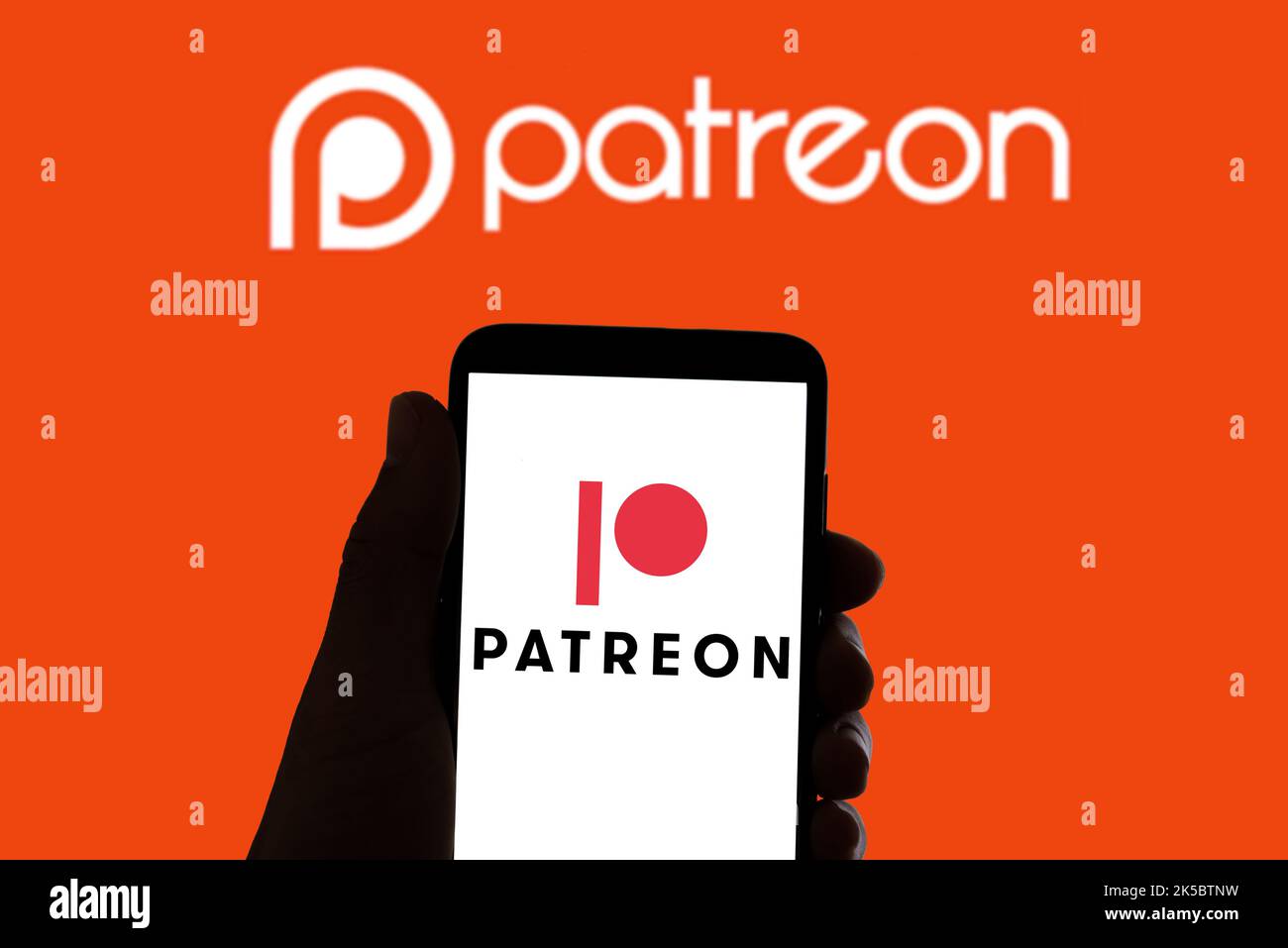 In this photo illustration the logo of the social network Patreon seen on the screen of mobile phone and in the background. Stock Photo