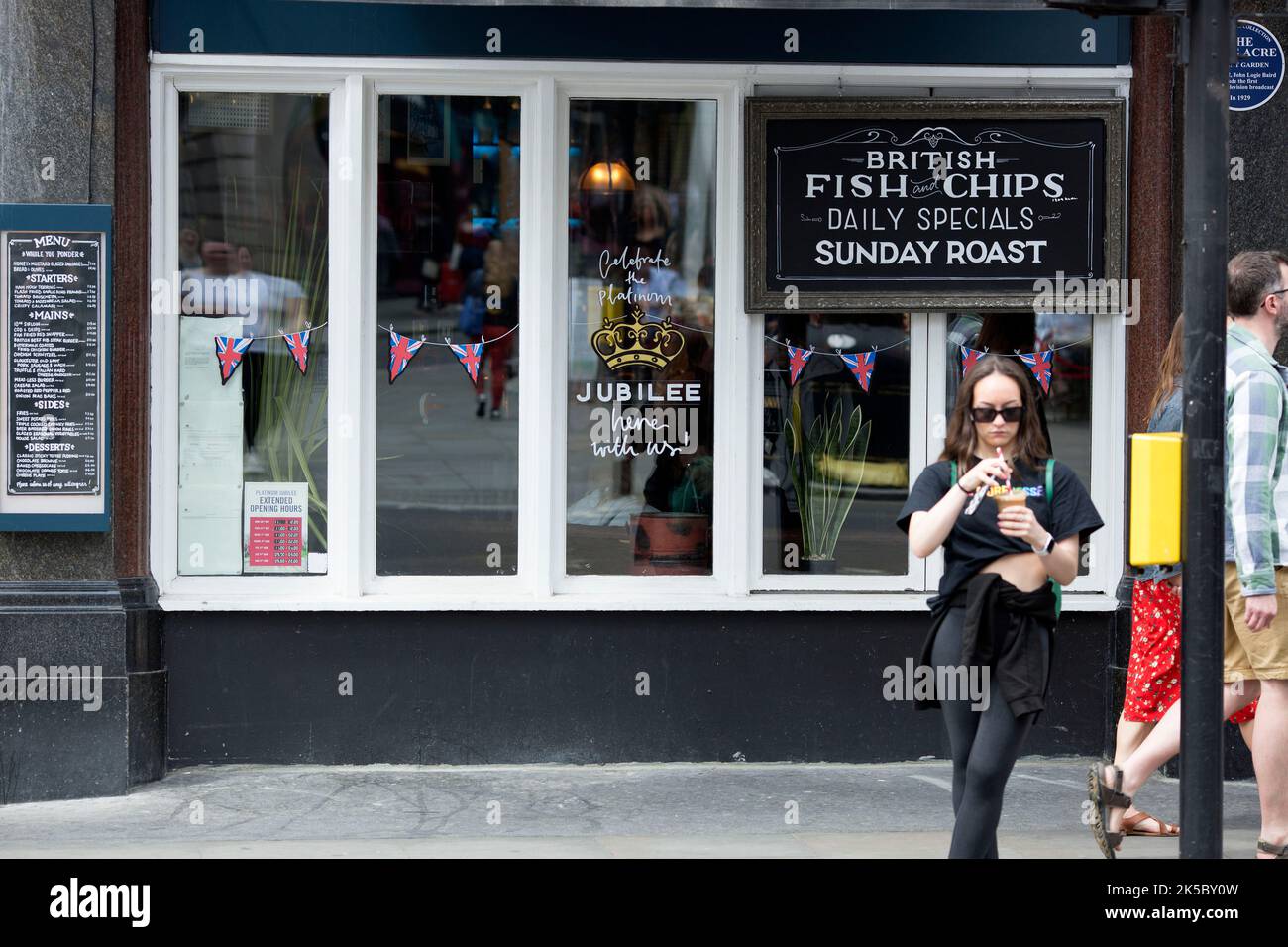 Platinum Jubilee decorations are seen on the window of a pub in central London ahead of the Platinum Jubilee celebrations. Stock Photo