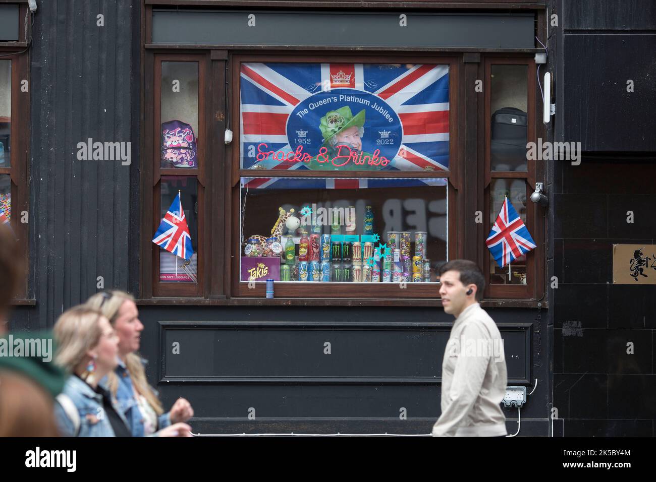 Platinum Jubilee decorations are seen on the window of a retail unit in