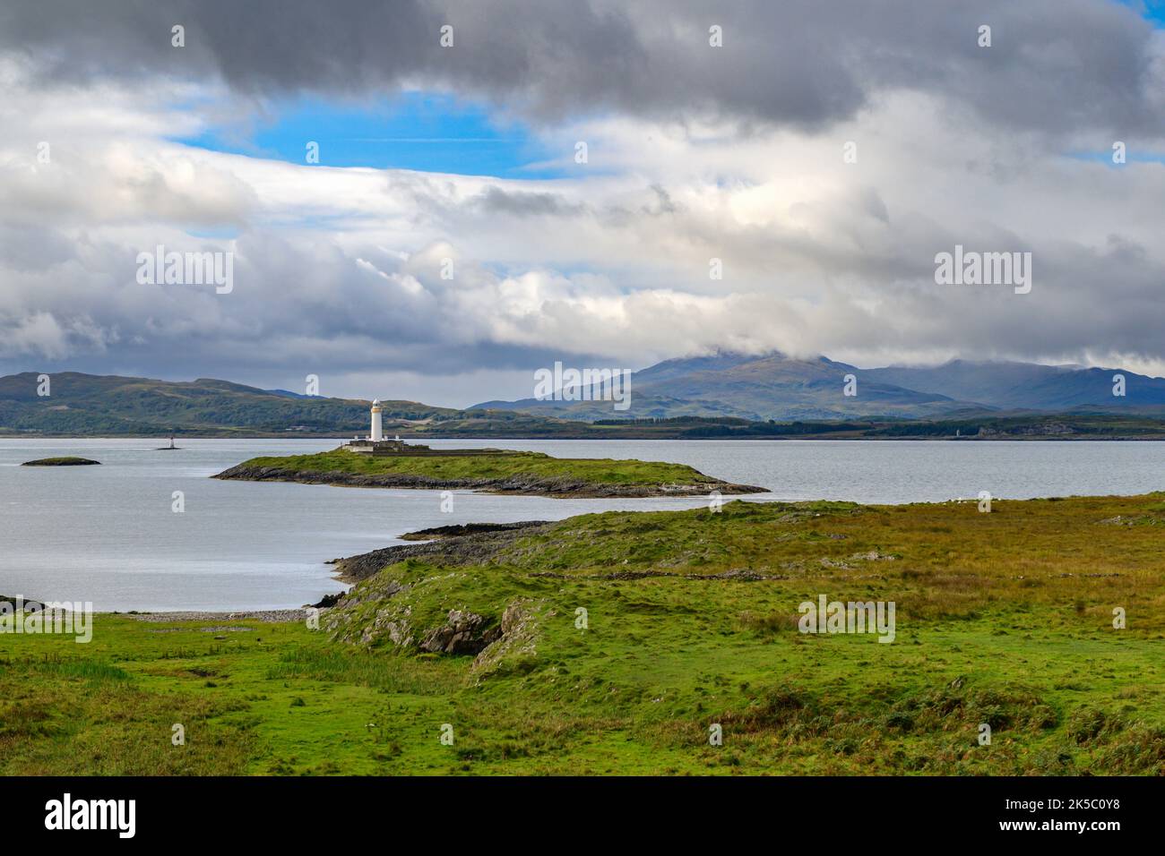 Eilean Musdile Lighthouse and the Isle of Mull from Lismore, Scotland Stock Photo