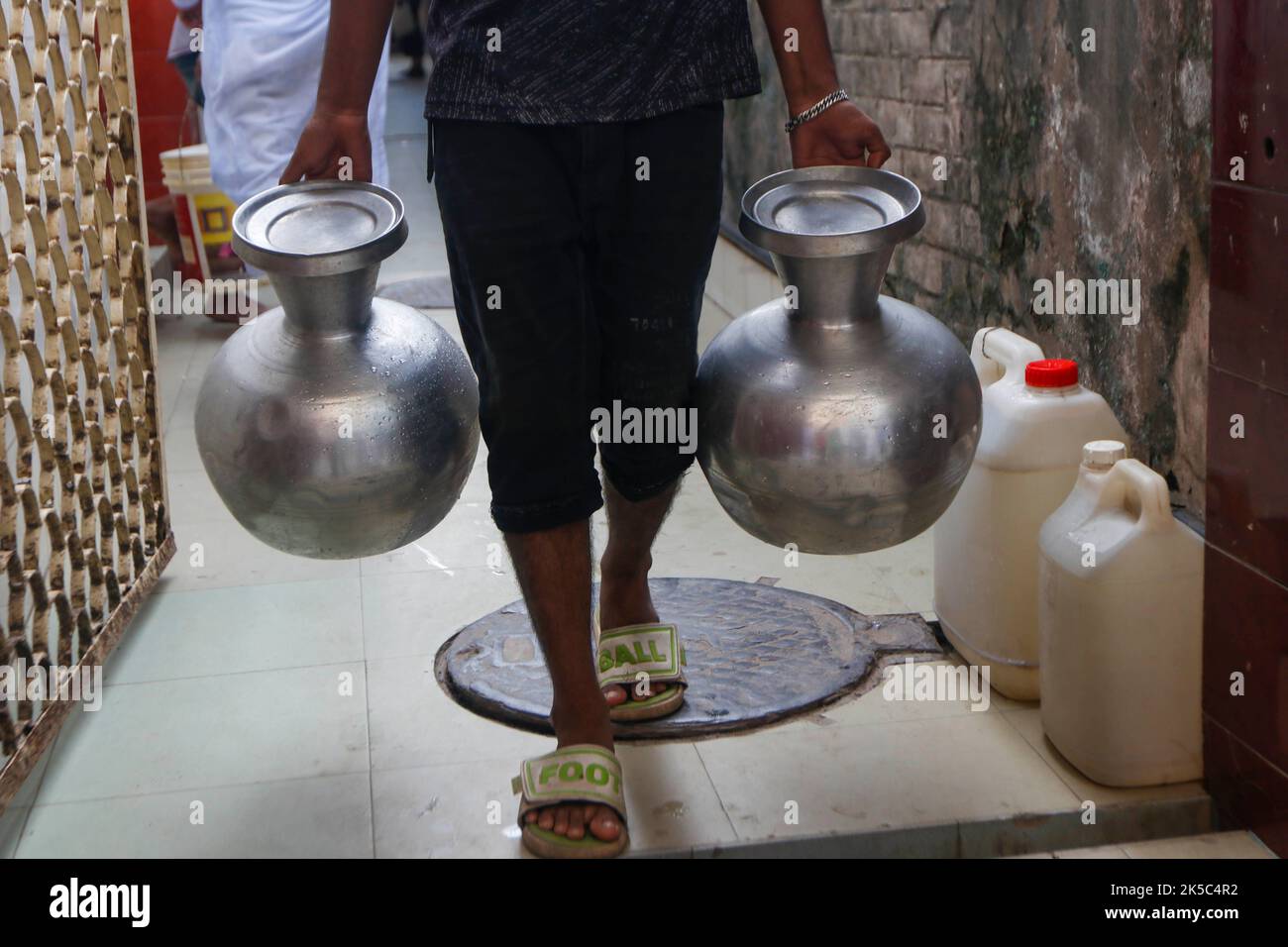 Dhaka, Dhaka, Bangladesh. 7th Oct, 2022. A man carries water jar after