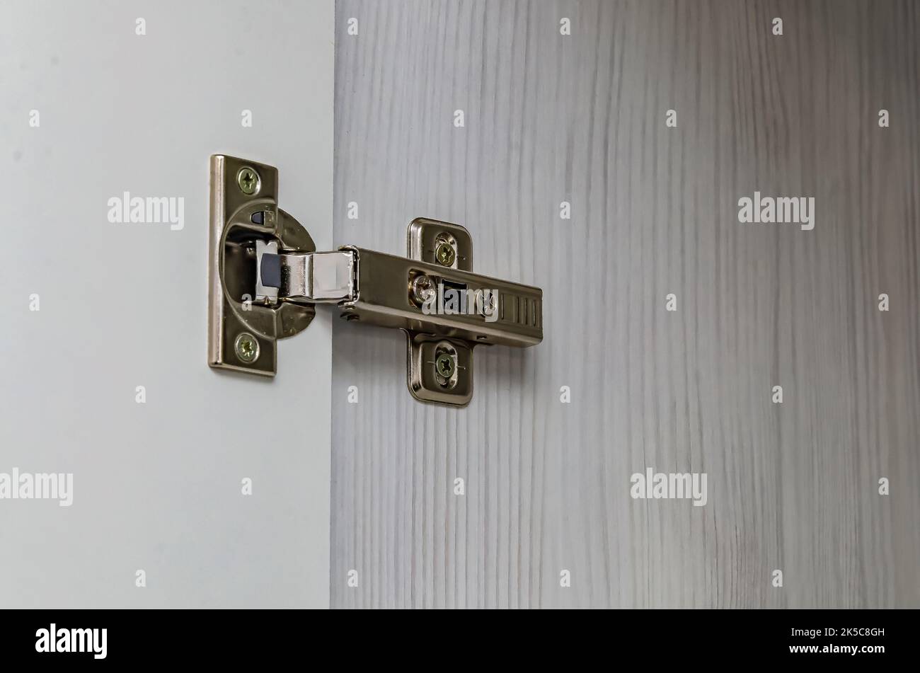 Furniture door hinge on white door Stock Photo Alamy