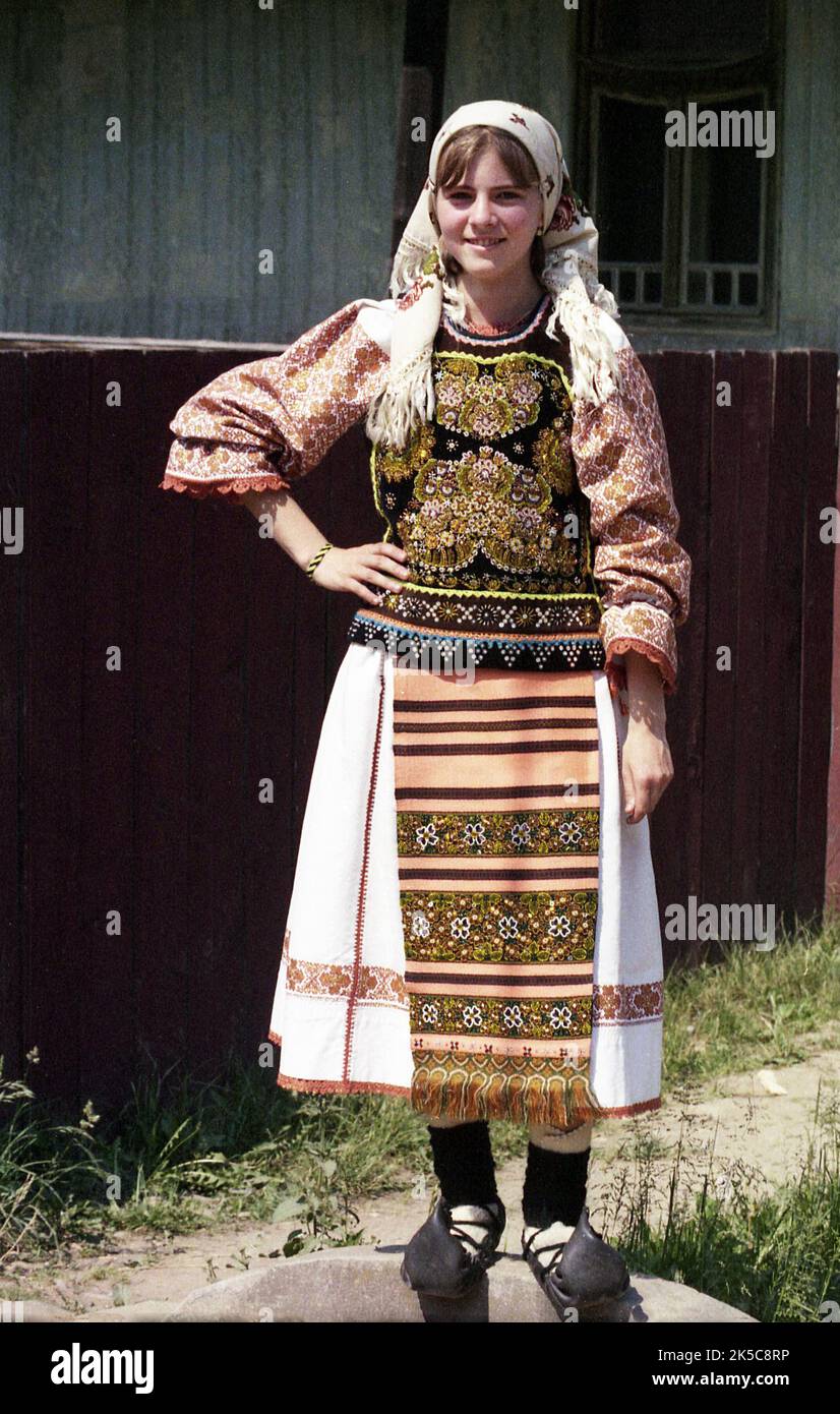 Maieru, Bistrița-Năsăud County, Romania, 2000. Young girl in beautiful  traditional folk costume, wearing "opinci", a handmade leather footwear  Stock Photo - Alamy