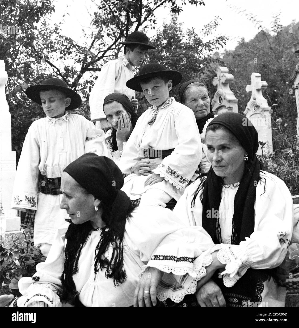 Bistrița-Năsăud County, Romania, approx. 1978. Villagers in a cemetery for a religious event, dressed up in the traditional folk clothing. Stock Photo