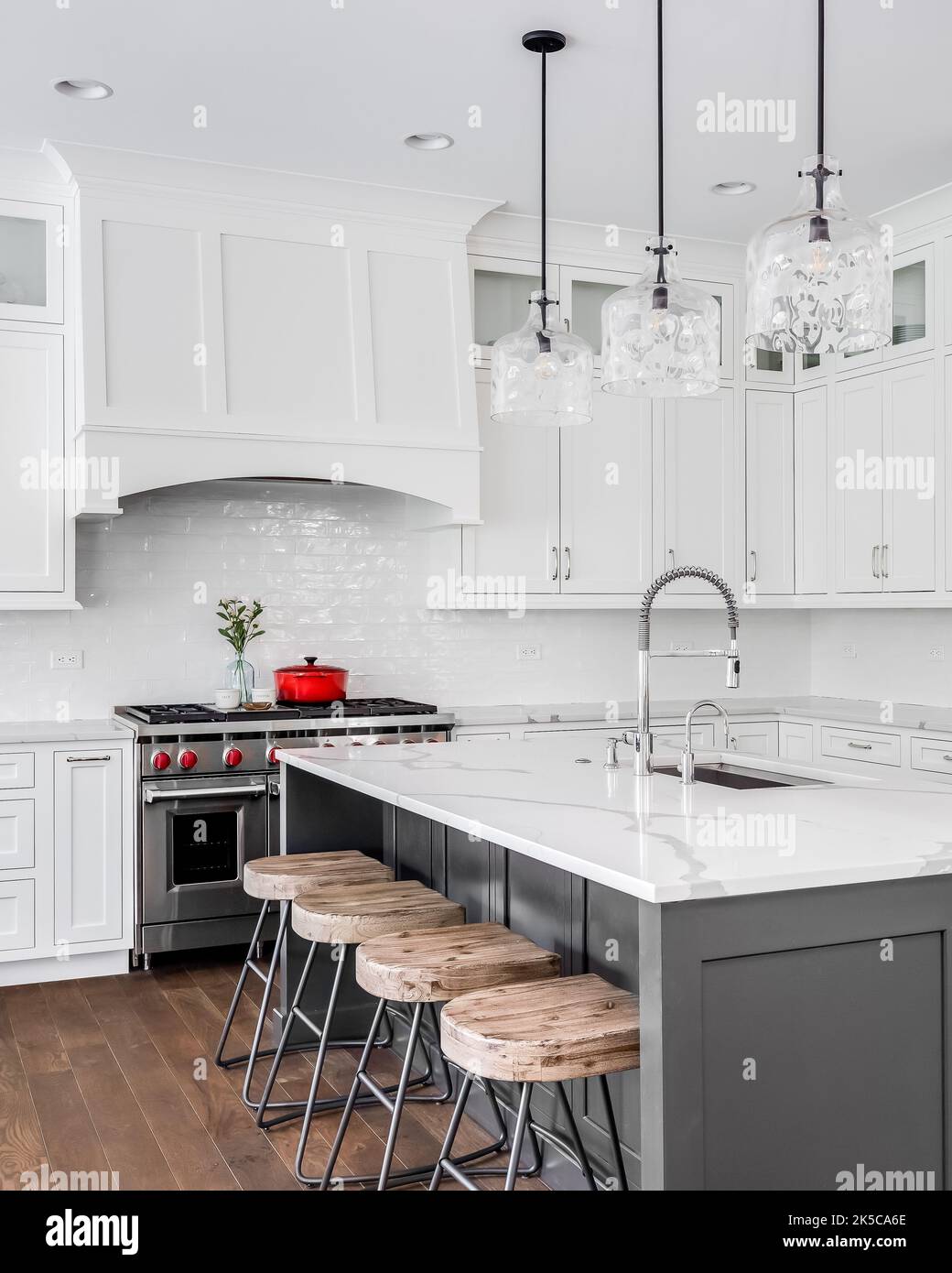 A large luxury kitchen with white granite countertops and cabinets ... - Granite Kitchen Cabinets Online High Rise Walls