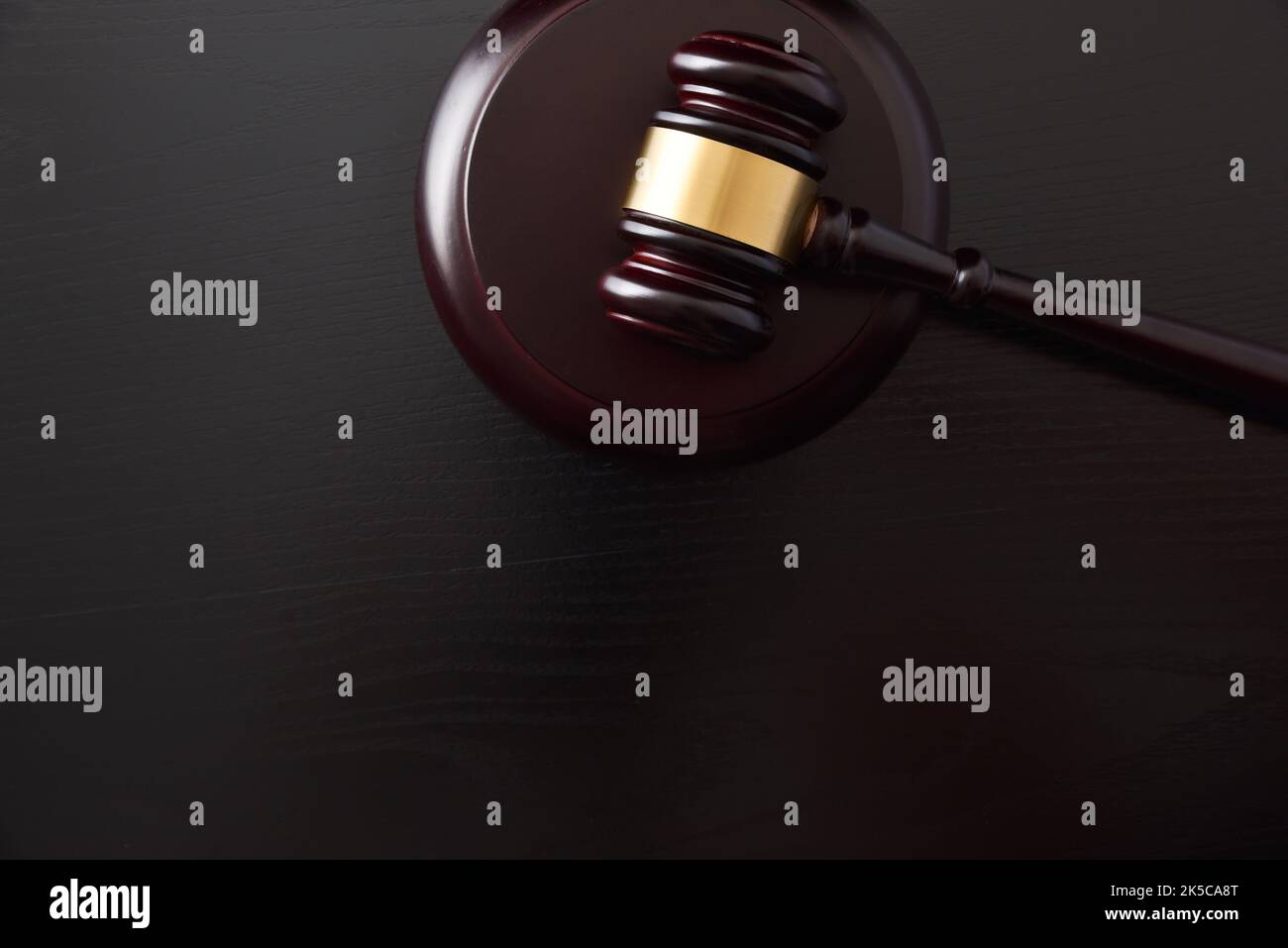 Detail of background of judge's gavel on white table and black isolated background. Top view Stock Photo
