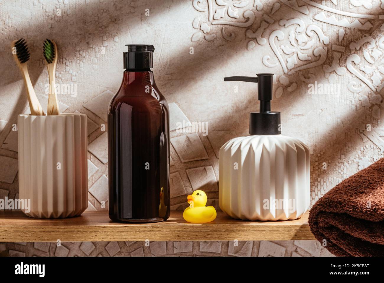 A mockup of a bottle of shower gel on a shelf in the bathroom Stock