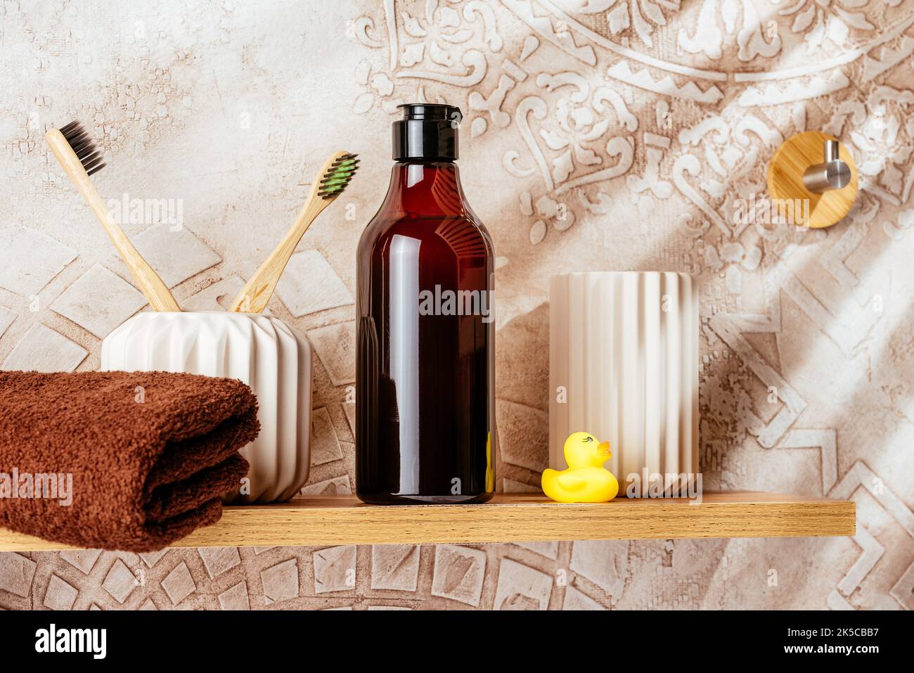 A mockup of a bottle of shower gel on a shelf in the bathroom Stock
