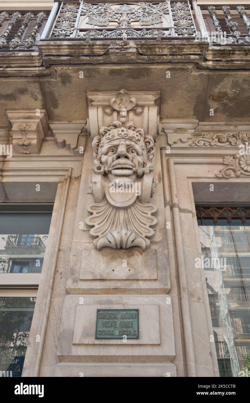 Beautiful indian male face carved in stone adorning the façade of a building, sign of Indianos history in Barcelona, El born, Spain. Stock Photo
