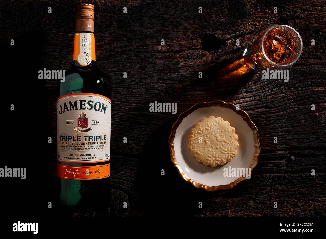Jameson whisky, bottle, glass, bowl with cookie Stock Photo Alamy