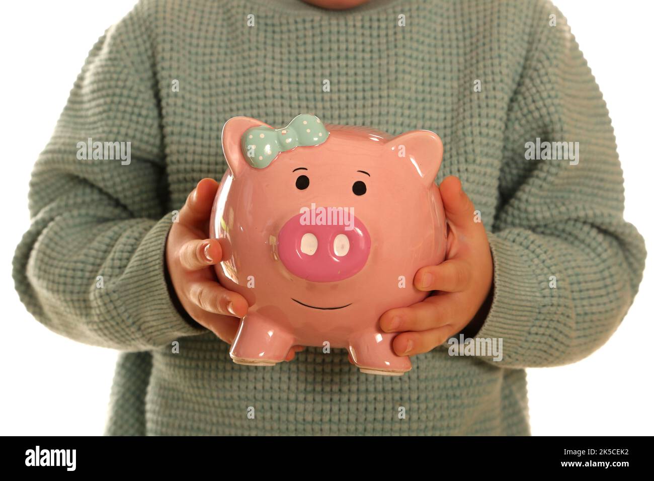 Child holding a piggy bank Stock Photo - Alamy