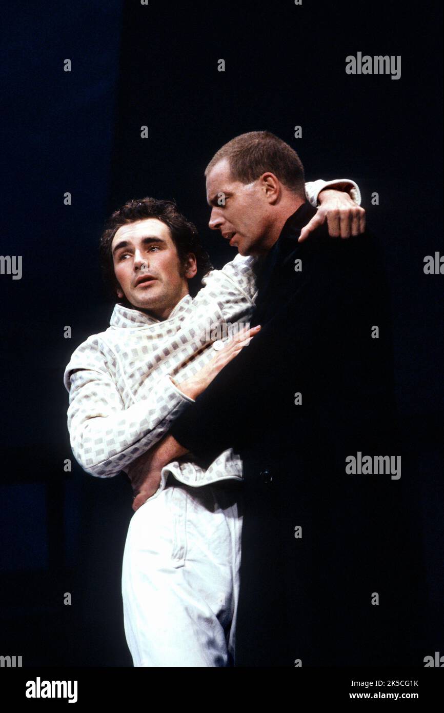 final scene, Hamlet is mortally wounded - l-r: Mark Rylance (Hamlet), Jack Ellis (Horatio) in HAMLET by Shakespeare at the Royal Shakespeare Company (RSC), Barbican Theatre, London EC2  23/11/1989  music: Claire van Kampen  design: Antony McDonald  lighting: Thomas Webster  fights: Alexis Denisof  director: Ron Daniels Stock Photo