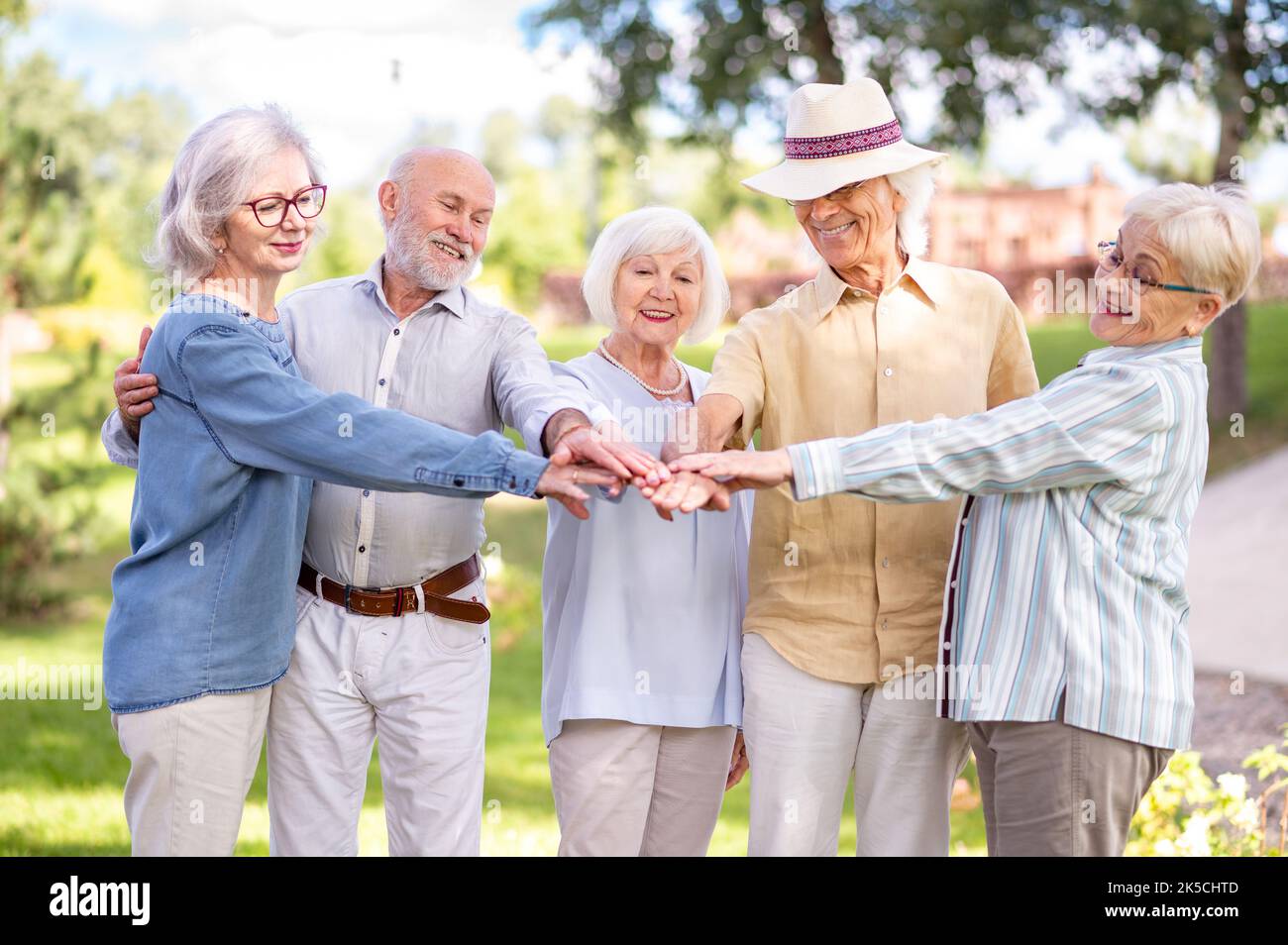 Group of happy elderly people bonding outdoors at the park Old people
