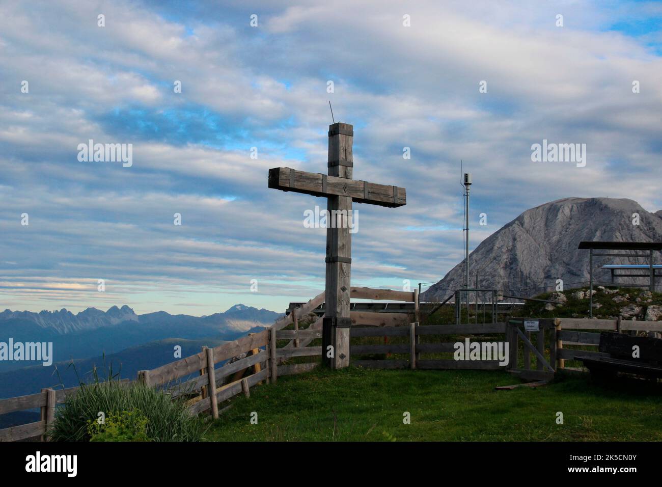 Cross in front of Rotmoosalm, alp, threatening sky, fence, sunset, Wetterstein Mountains, Gaistal, Leutasch, Tyrol, Austria Stock Photo