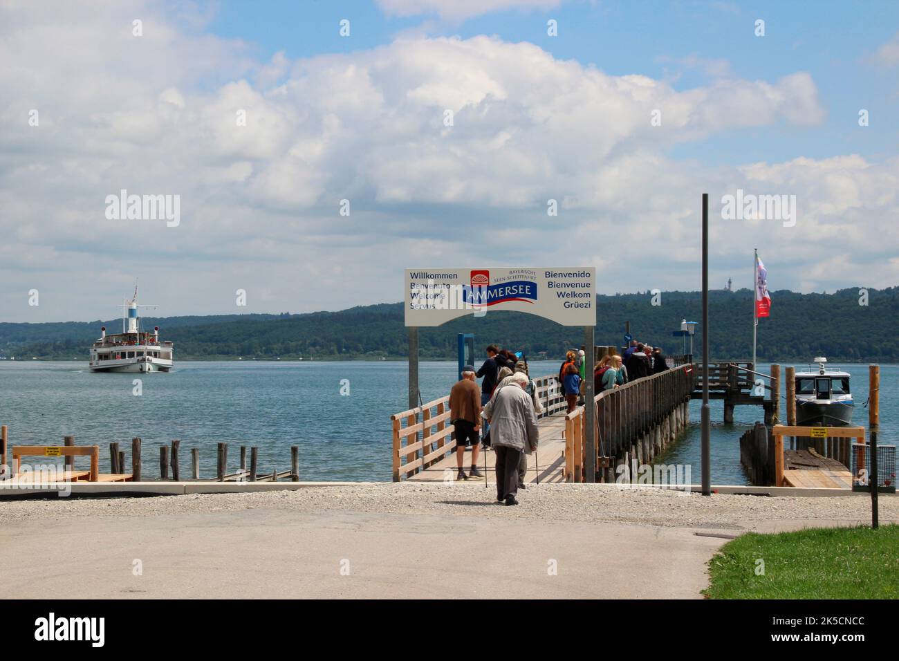 Summer atmosphere in Dießen am Ammersee, ship MS Herrsching, atmospheric, sky white-blue, jetty, tourists, Germany, Upper Bavaria, 5-Seen-Land Stock Photo