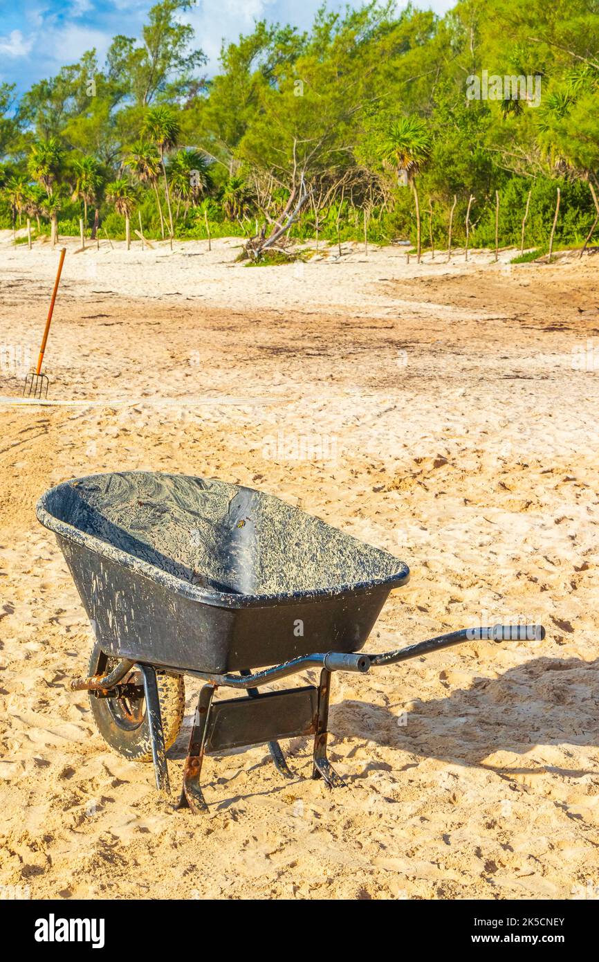 Cleaning the beach with wheelbarrow pitchfork Garden Rake Leaf Broom