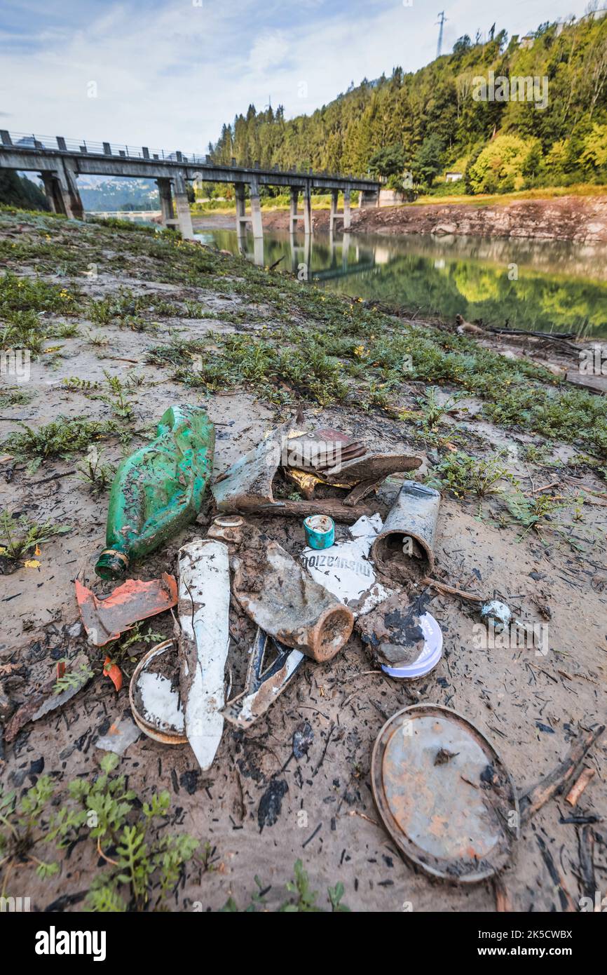 Italy, Veneto, province of Belluno, Centro Cadore lake. Environmental pollution from garbage and plastic emerged with the withdrawal of water from the lake Stock Photo