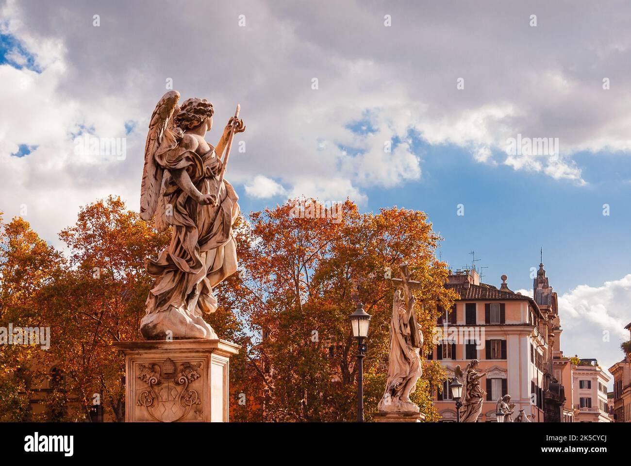 Autumn in Rome. Saint Angel Brdige wonderful baroque statues with autumnal red leaves Stock Photo