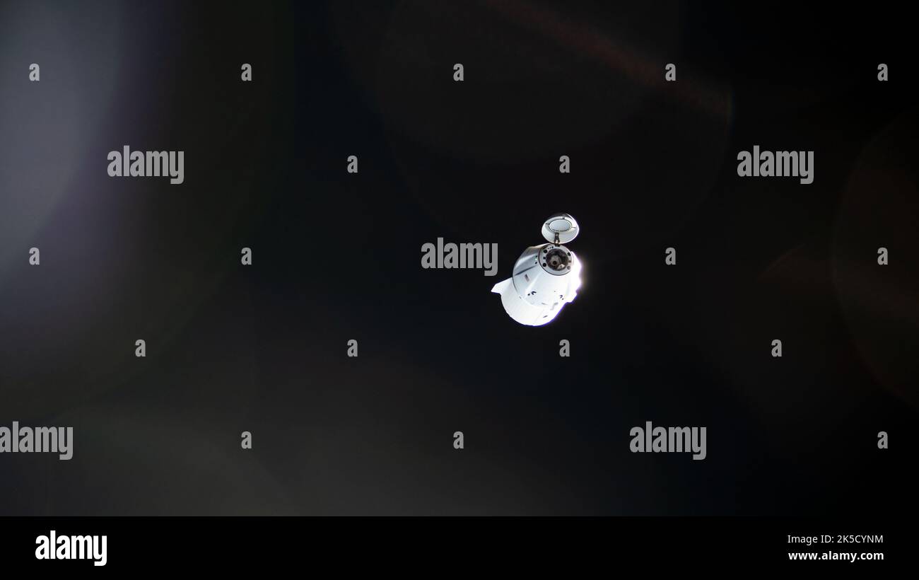 The SpaceX Dragon resupply ship, packed with over 4,000 pounds of return cargo and science experiments for analysis, is pictured departing the vicinity of the International Space Station several minutes after undocking from the Harmony module's forward port. Stock Photo