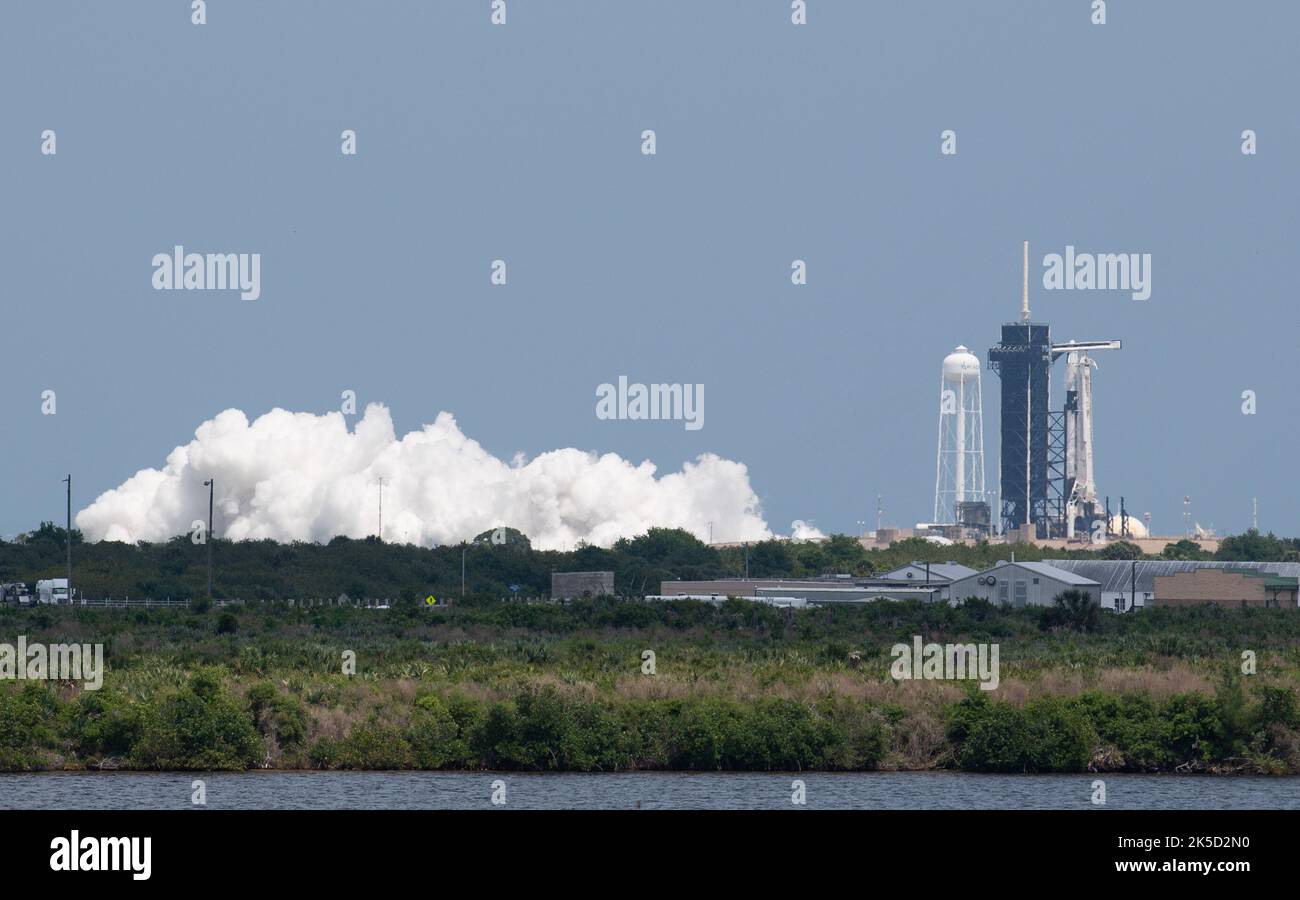 A SpaceX Falcon 9 rocket with the company's Crew Dragon spacecraft aboard is seen on the launch pad at Launch Complex 39A during a brief static fire test ahead of Axiom Mission 1 (Ax-1), Wednesday, April 6, 2022, at NASA’s Kennedy Space Center in Florida. The Ax-1 mission is the first private astronaut mission to the International Space Station.  Ax-1 crew members Commander Michael López-Alegría of Spain and the United States, Pilot Larry Connor of the United States, and Mission Specialists Eytan Stibbe of Israel, and Mark Pathy of Canada are scheduled to launch on no earlier than March 20, fr Stock Photo