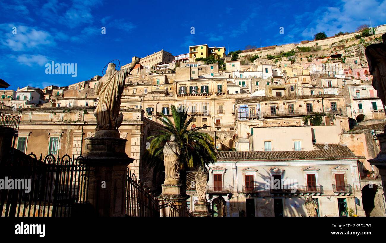 Italy, Sicily, baroque corner, baroque town, Modica, old town, morning light, view from the cathedral to the opposite built hillside, old town buildings, blue sky with few white clouds Stock Photo