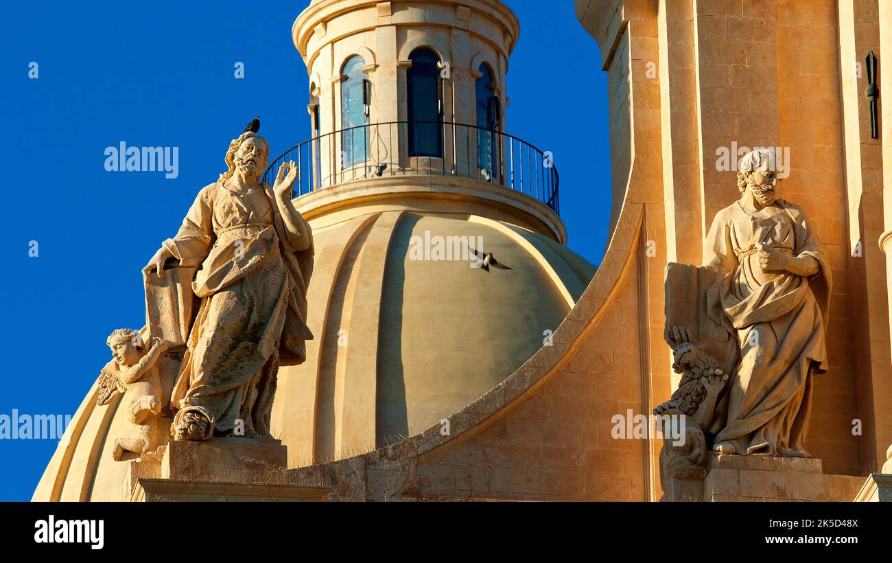 Italy, Sicily, baroque angle, baroque city, Noto, baroque architecture, cathedral, tower, dam on roof, dove, soft light, deep blue sky Stock Photo