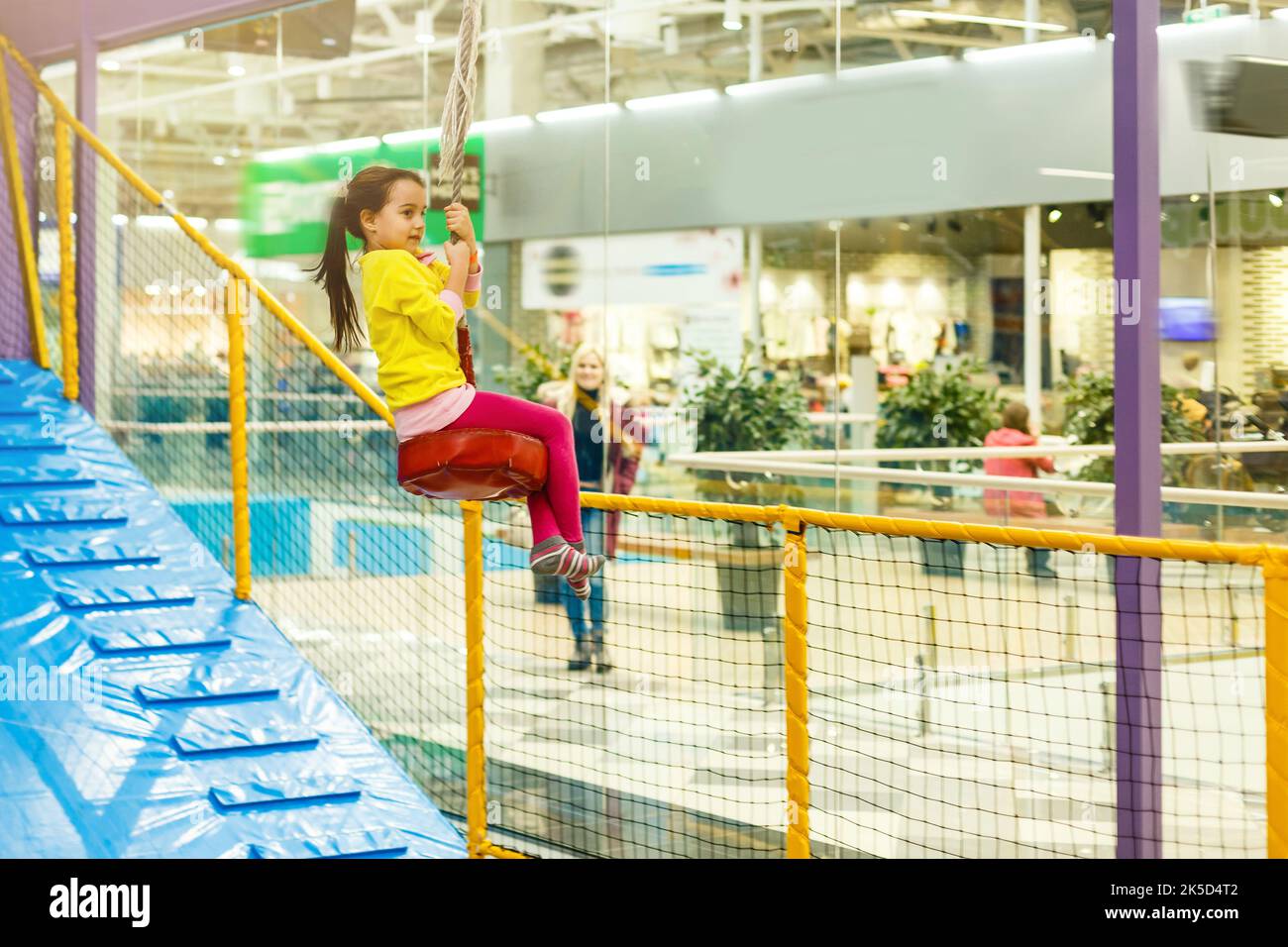Child jumping on colorful playground trampoline. Kids jump in inflatable bounce castle on