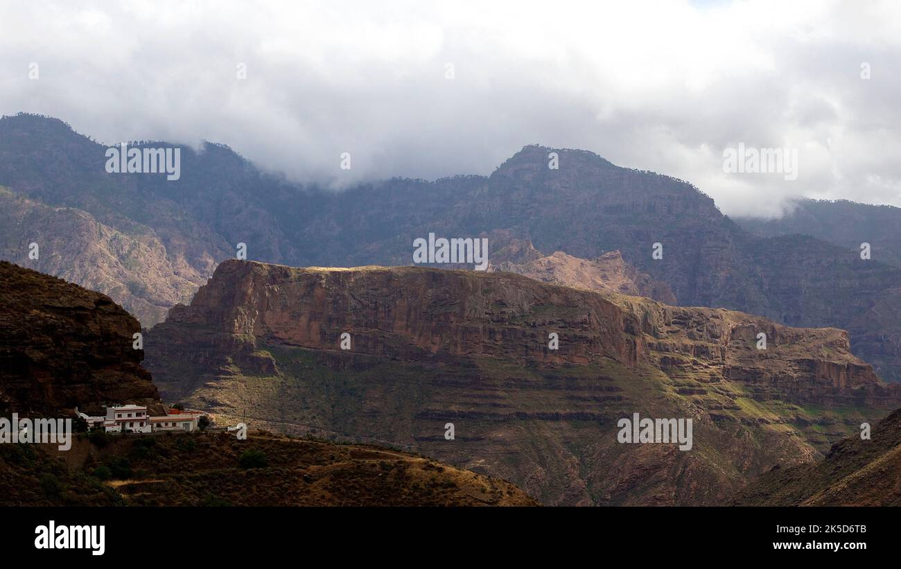 Spain, Canary Islands, Gran Canaria, Barranco de la Aldea, cloudy weather, Massif Central, Acusa village, building, cave dwellings Stock Photo