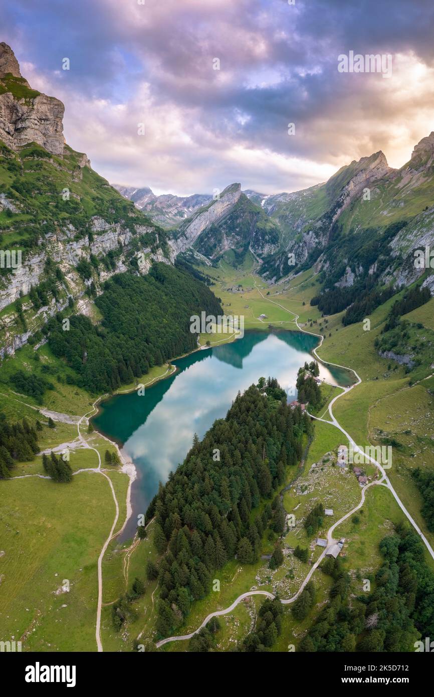 View of Seealpsee and the surrounding mountains at sunset. Canton of Appenzell, Alpstein, Switzerland, Europe. Stock Photo