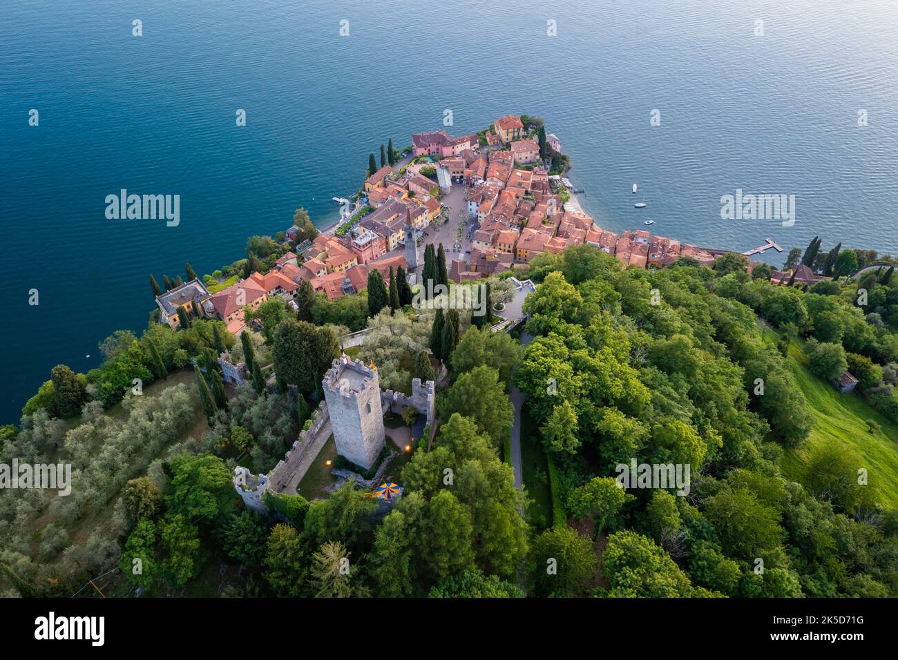 Aerial view of the castle of Vezio, dominating lake Como and Varenna town at sunset. Vezio, Perledo, Lecco district, Lombardy, Italy, Europe. Stock Photo