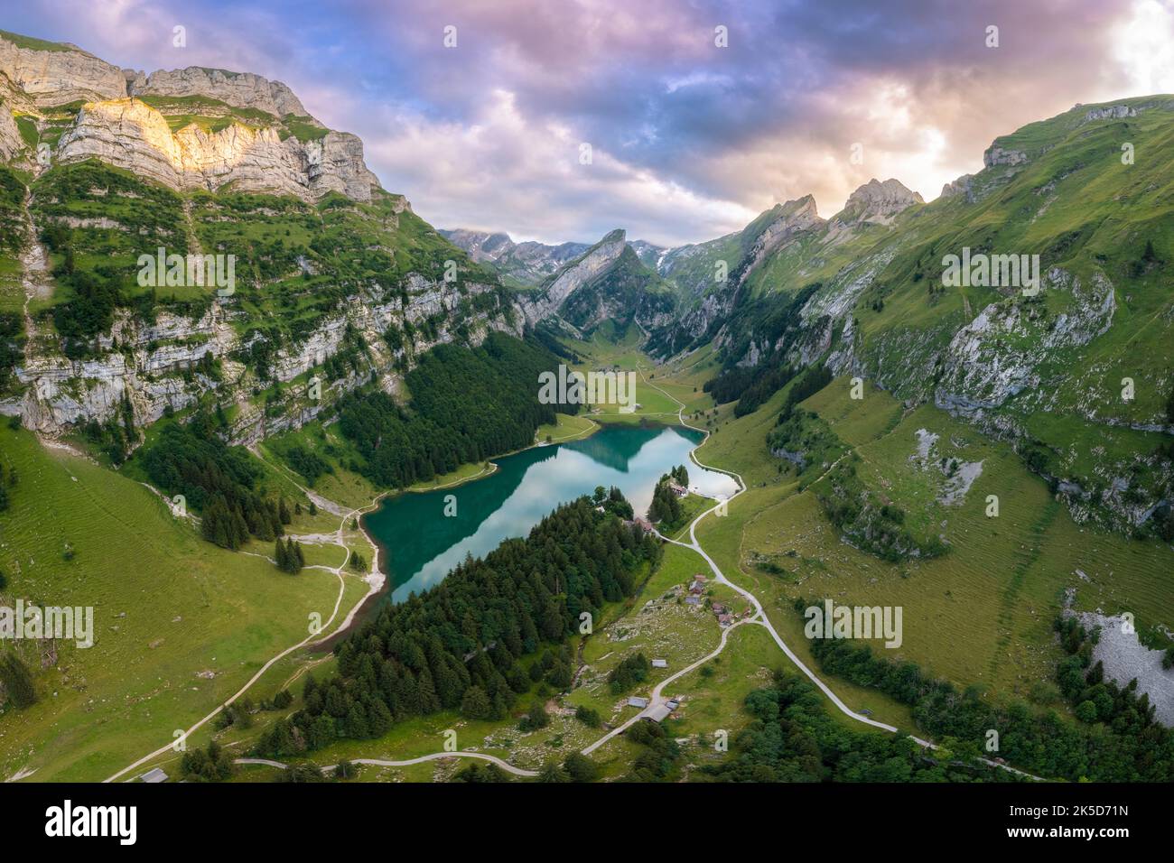 View of Seealpsee and the surrounding mountains at sunset. Canton of Appenzell, Alpstein, Switzerland, Europe. Stock Photo