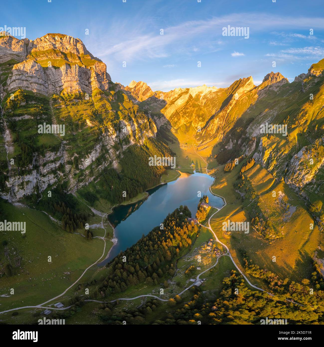 View of Seealpsee and the surrounding mountains at sunrise. Canton of Appenzell, Alpstein, Switzerland, Europe. Stock Photo