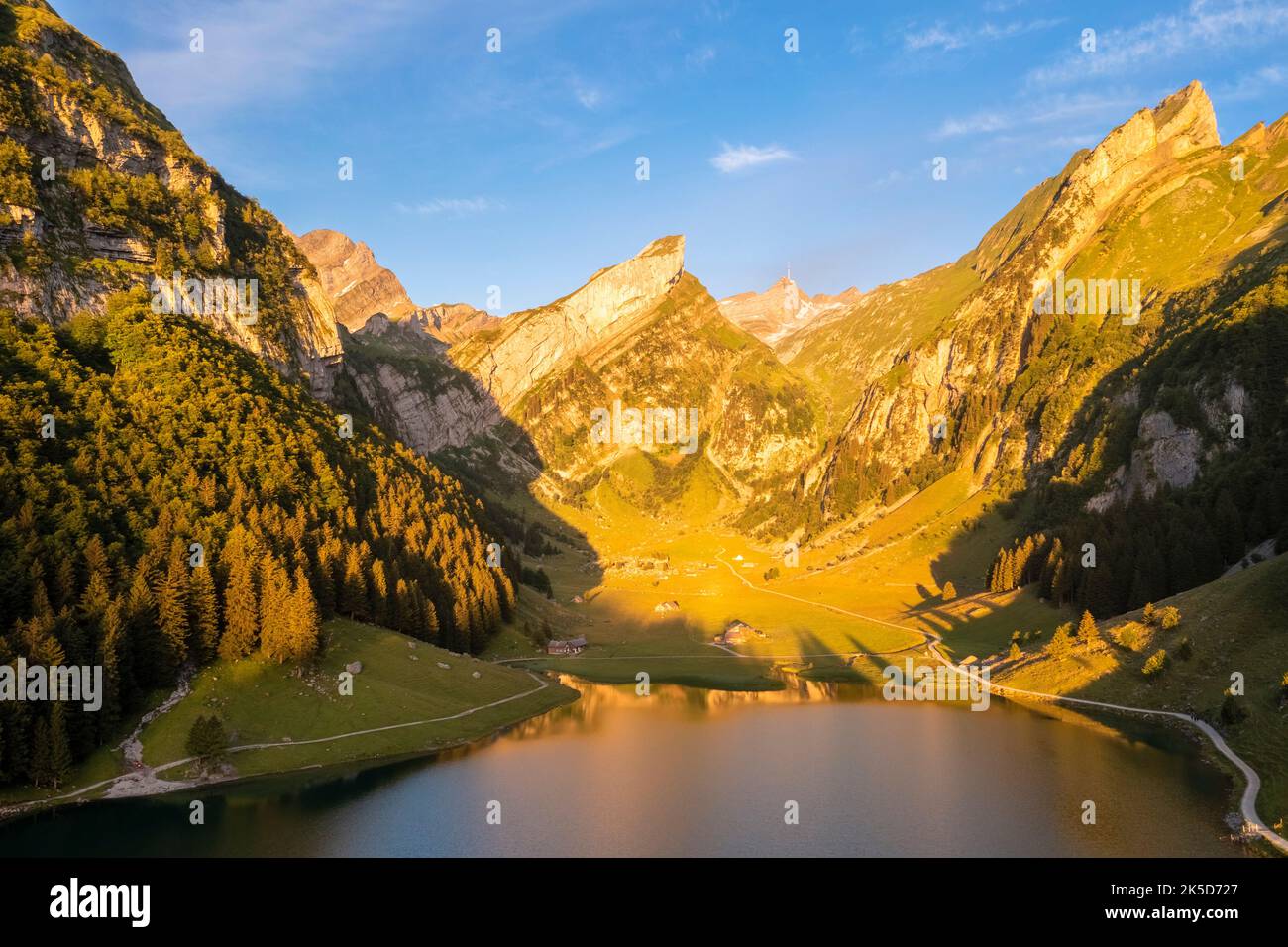 View of Seealpsee and the surrounding mountains at sunrise. Canton of Appenzell, Alpstein, Switzerland, Europe. Stock Photo