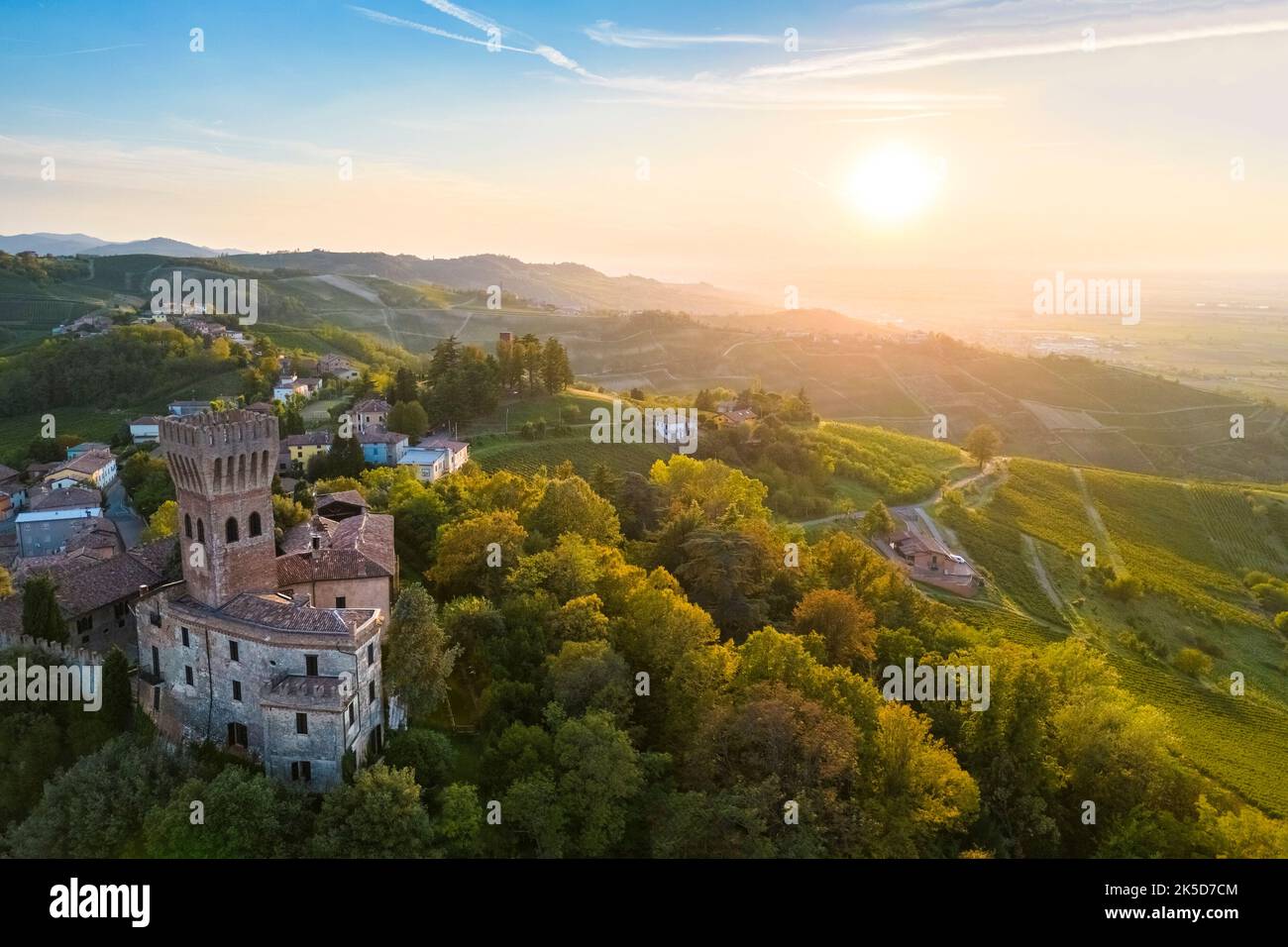 Aerial view of the Cigognola castle and vineyards at sunset. Cigognola