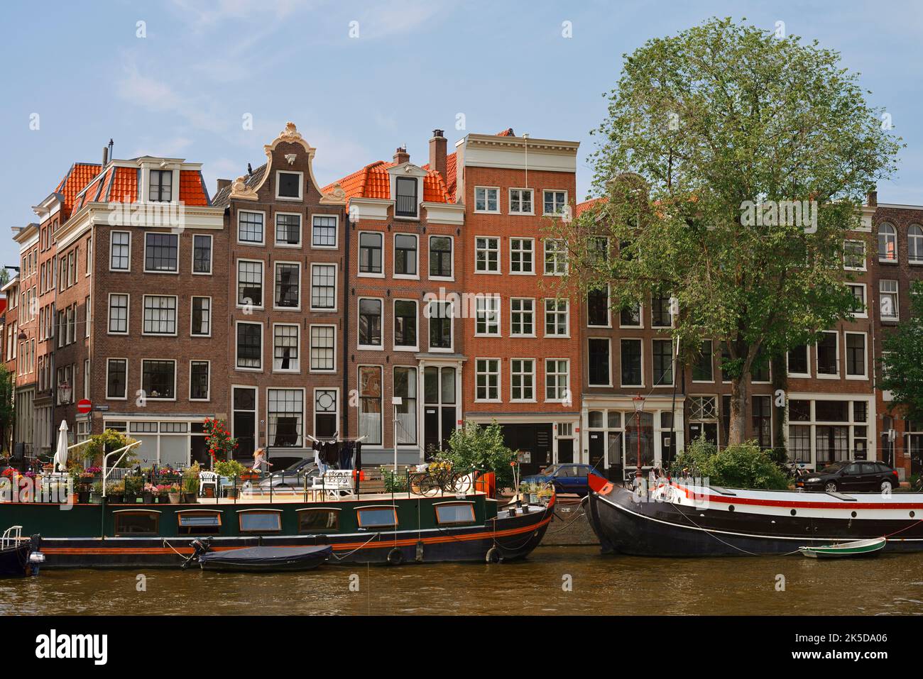 Houses and canal with ship, Amsterdam, North Holland, Netherlands Stock