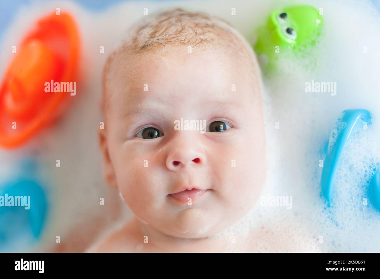 Baby bath time. Closeup detail view of mother bathing cute little