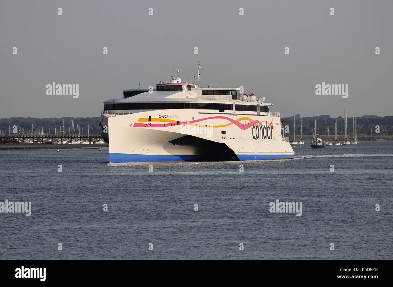 The high speed cross channel ferry CONDOR LIBERATION leaves the International port and heads for the Channel Islands Stock Photo